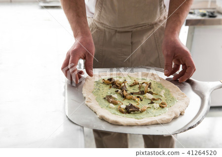 Fresh original Italian raw pizza, preparation in traditional style. Hands of chef baker making pizza Fresh original Italian raw pizza, preparation in traditional style. Hands of chef baker making pizza 41264520