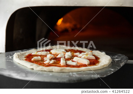 Italian pizza is cooked in a wood-fired oven. Close up Italian pizza is cooked in a wood-fired oven. Close up 41264522