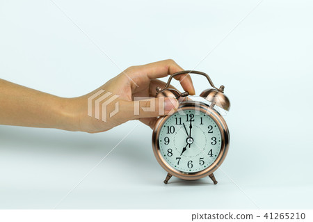 hands holding Vintage alarm clock on white hands holding Vintage alarm clock on white 41265210