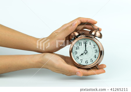 hands holding Vintage alarm clock on white hands holding Vintage alarm clock on white 41265211