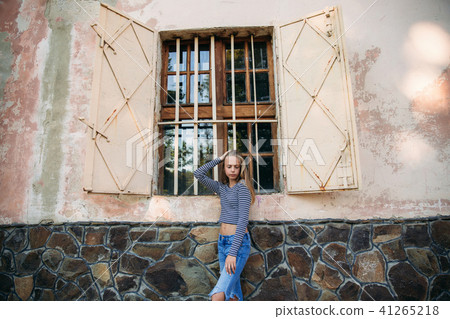 blonde teenage girl in striped blouse near the window blonde teenage girl in striped blouse near the window 41265218