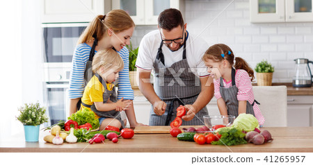 happy family with children preparing vegetable salad . 41265957