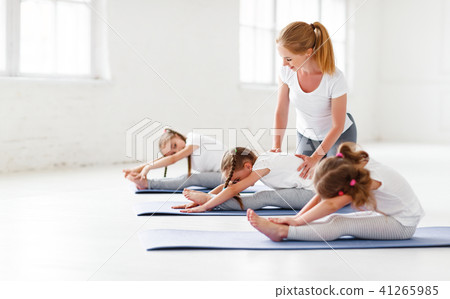 children practicing engaged in gymnastics and yoga with teacher children practicing engaged in gymnastics and yoga with teacher 41265985