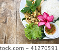 Green curry chicken in a plate on a wooden table.  41270591