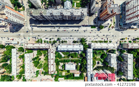 Aerial city view with crossroads and roads, houses, buildings, parks and parking lots. Sunny summer Aerial city view with crossroads and roads, houses, buildings, parks and parking lots. Sunny summer 41272198