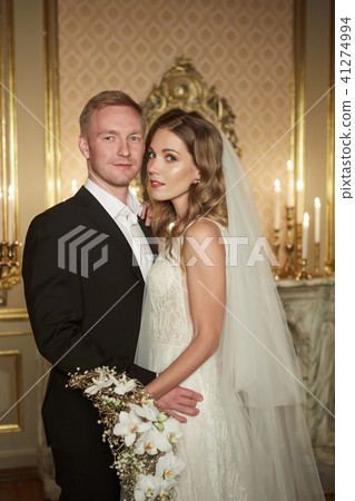 Wedding couple in a luxurious interior in the Baroque style is hugging each other. Beautiful model 41274994