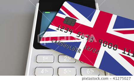Payment or POS terminal with credit card featuring flag of Great Britain. British retail commerce or 41275027