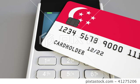 Payment or POS terminal with credit card featuring flag of Singapore. Singaporean retail commerce or 41275206