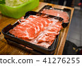 Freshly sliced pork meat on wooden table 41276255