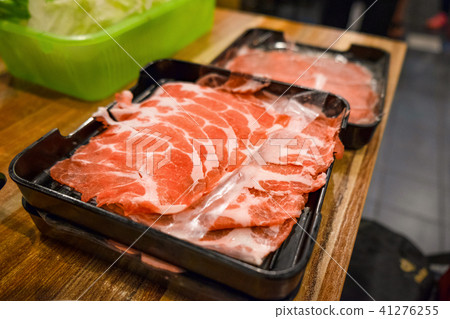 Freshly sliced pork meat on wooden table Freshly sliced pork meat on wooden table 41276255