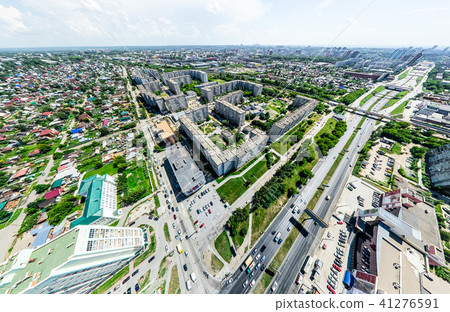 Aerial city view with crossroads and roads, houses, buildings, parks and parking lots. Sunny summer 41276591