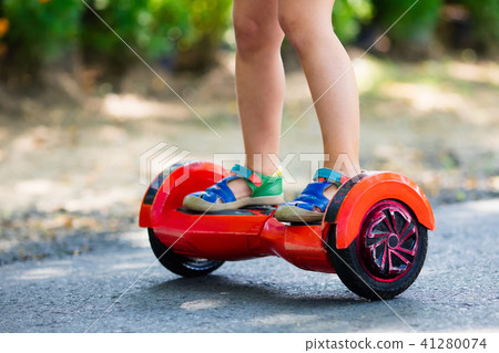 Child on hover board. Kids ride scooter. 41280074