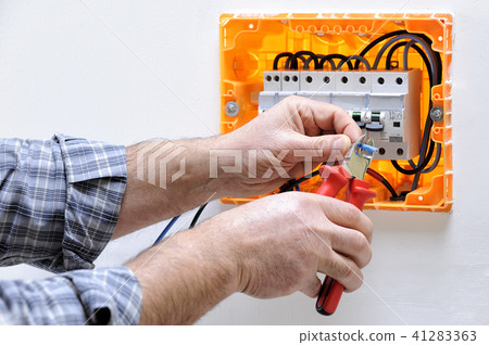 Electrician at work on an electrical panel 41283363