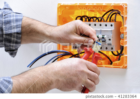 Electrician at work on an electrical panel 41283364
