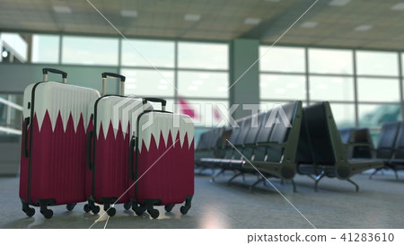 Travel suitcases featuring flag of Qatar. Qatari tourism conceptual 3D rendering 41283610