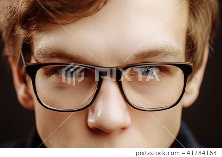 close up cropped photo of man with beautiful blue eyes in glasses close up cropped photo of man with beautiful blue eyes in glasses 41284163