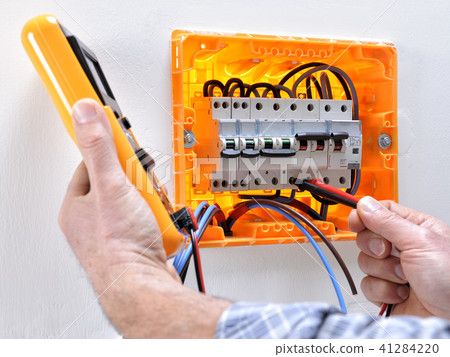 Electrician at work on an electrical panel 41284220