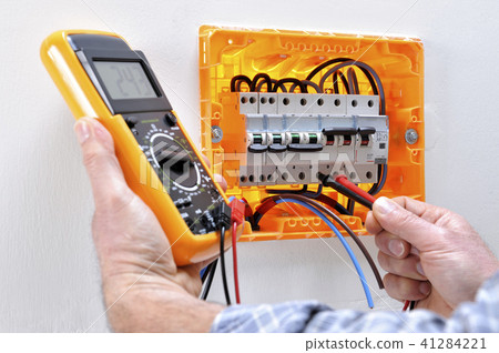 Electrician at work on an electrical panel 41284221