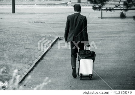business man walking with suitcase in the street business man walking with suitcase in the street 41285079