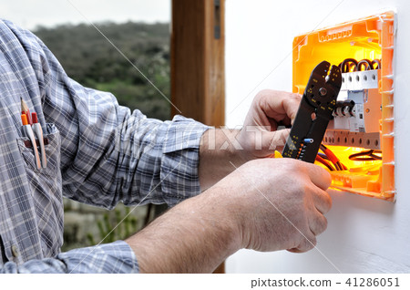 Electrician at work on an electrical panel Electrician at work on an electrical panel 41286051
