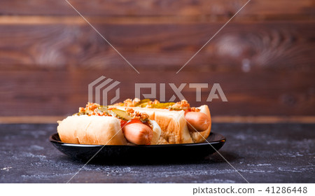 Photo of hotdogs on black plate Photo of hotdogs on black plate 41286448