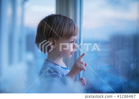Child looking at window 41286467