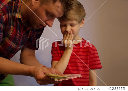 Man and boy hold money in their hands Man and boy hold money in their hands 41287655