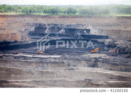Dump trucks and excavator working at coal mine 41288188