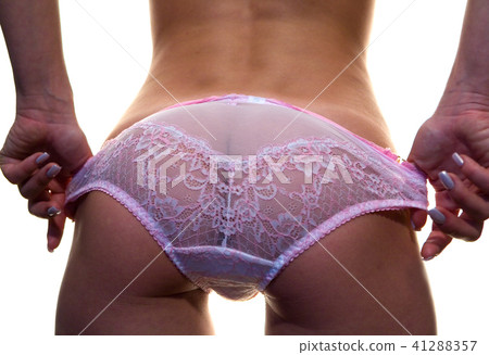 A beautiful slender girl takes off her panties. 41288357