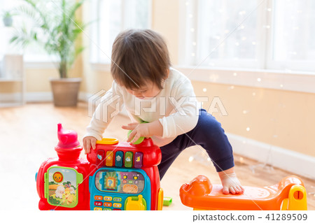 Happy toddler boy playing Happy toddler boy playing 41289509