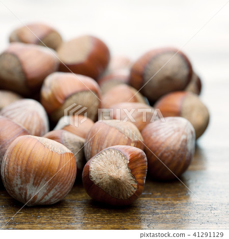 NutsNuts at wooden table NutsNuts at wooden table 41291129