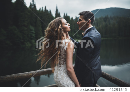 Perfect couple bride, groom posing and kissing in their wedding day 41291843