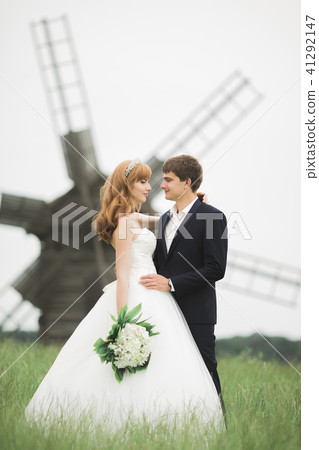 Happy wedding couple walking in a botanical park Happy wedding couple walking in a botanical park 41292147