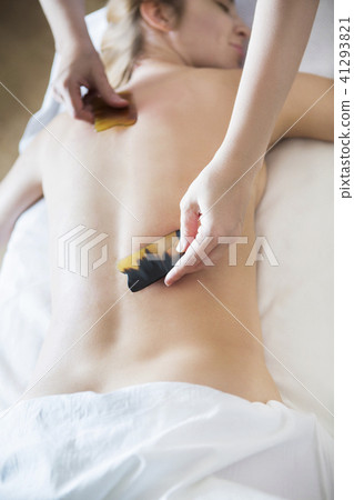 Young woman take back treatment at health spa Young woman take back treatment at health spa 41293821