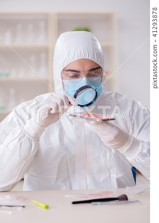 Expert criminologist working in the lab for evidence Expert criminologist working in the lab for evidence 41293878