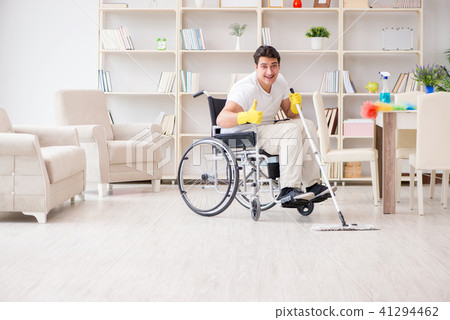 Disabled man cleaning floor at home Disabled man cleaning floor at home 41294462