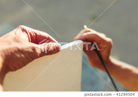 Close up man working of Architect sketching a construction project on his plane project at site Close up man working of Architect sketching a construction project on his plane project at site 41294504
