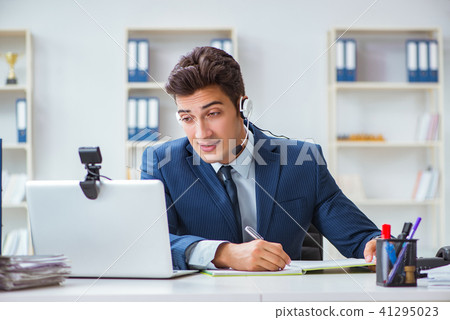 Young help desk operator working in office Young help desk operator working in office 41295023