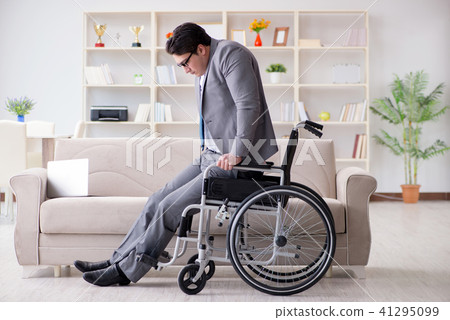 Dsabled businessman on wheelchair working home 41295099