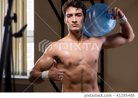 Muscular ripped man with big water bottle 41295486
