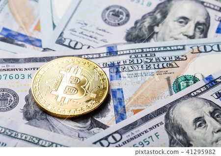 Bitcoins on dollar banknotes background Bitcoins on dollar banknotes background 41295982