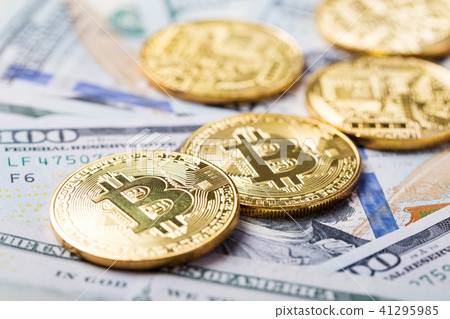 Bitcoins on dollar banknotes background 41295985