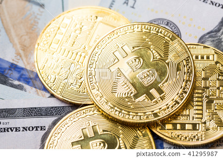 Bitcoins on dollar banknotes background 41295987