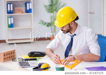 Architect working in his studio on new project 41297175