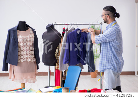 Male tailor working in the workshop on new designs 41297283
