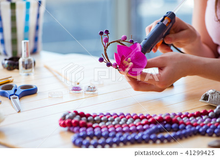 Woman making jewelry at home Woman making jewelry at home 41299425