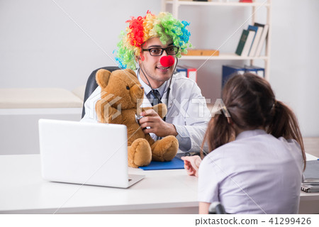 Funny pediatrician with little girl at regular check-up Funny pediatrician with little girl at regular check-up 41299426