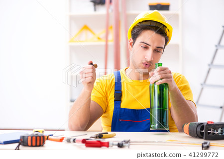 Drunk engineer working in the workshop Drunk engineer working in the workshop 41299772