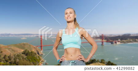 woman in sports clothes over golden gate bridge 41299882