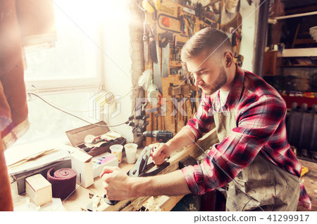 carpenter working with plane and wood at workshop carpenter working with plane and wood at workshop 41299917